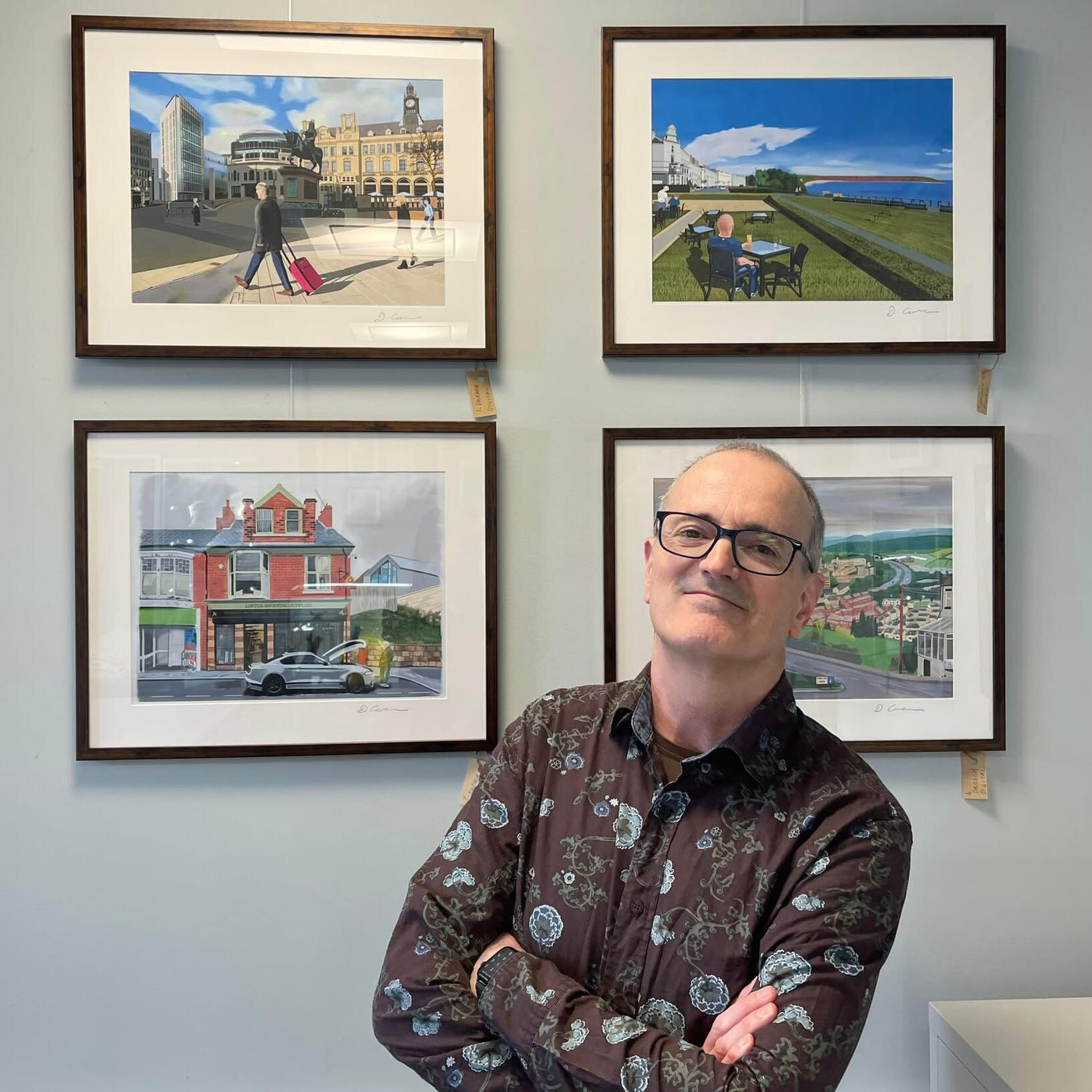 SCENES OF YORKSHIRE Artist Daragh Corcoran posing with his paintings in a gallery